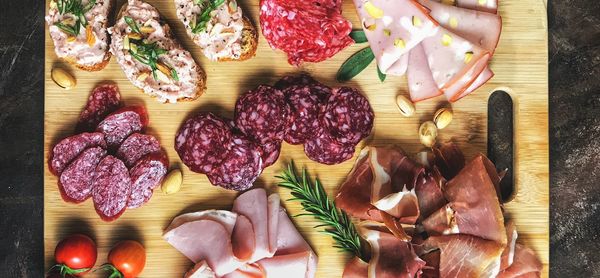 Various types of sausage on a wooden board